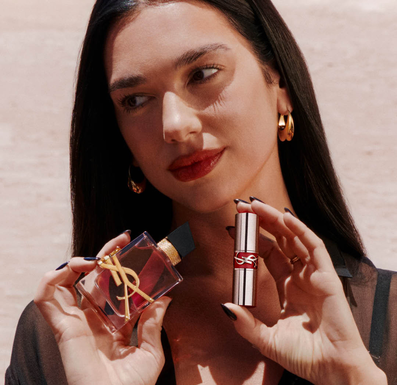 YSL Beauté ambassador Dua Lip poses with YSL lip oil and Libre perfume