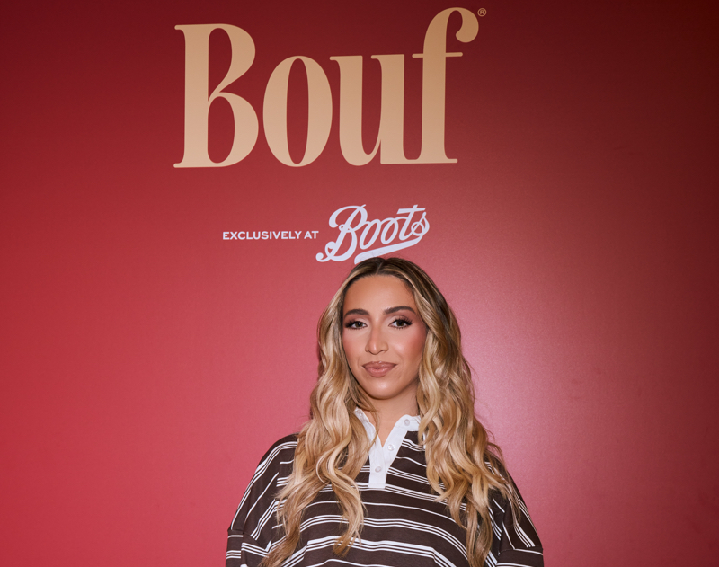 GK Barry in front of a poster for Bouf hair care launch in the UK